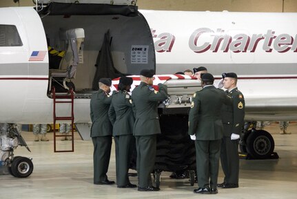 The Army Color Guard accepts the casket carrying the remains of Pfc. Francheska Velez of Chicago on Nov. 16, 2009. The transfer occurred in the hanger of the Company B, 935th Aviation and Company B, 1st Battalion, 106th Aviation Armory in Chicago. Velez was one of 13 people slain during the Fort Hood shootings in November 2009. (Photo by Master Sgt. Scott Thompson, Illinois National Guard)