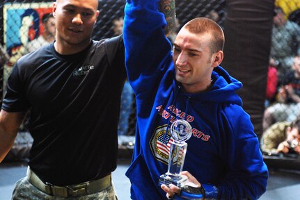 Sgt. 1st Class Austin Randolph holds up the arm of Staff Sgt. Matthew Stemmler of the Virginia National Guard after he defeated Staff Sgt. Justin Gottke in the lightweight final match during the Army National Guard Comabatives Tournament at Fort Benning, Ga., March 28, 2010. Stemmler was undefeated through all four matches he fought in the tournament.