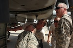 Master Sgt. Justin Likens, an aircraft crew chief with the 188th Fighter Wing from the Arkansas National Guard, shows the inner workings of the A-10 aircraft's 30-millimeter Gatling gun to members of the Arkansas Agriculture Development Team on March 19, 2010. The ADT dropped by the flight line to visit their fellow Arkansans deployed at Kandahar Airfield, Afghanistan. The 188th currently has over 200 of its members deployed as part of the 451st Air Expeditionary Wing at Kandahar. The ADT Team is in Kandahar for some training before moving out to their forward operating base.