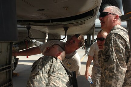 Master Sgt. Justin Likens, an aircraft crew chief with the 188th Fighter Wing from the Arkansas National Guard, shows the inner workings of the A-10 aircraft's 30-millimeter Gatling gun to members of the Arkansas Agriculture Development Team on March 19, 2010. The ADT dropped by the flight line to visit their fellow Arkansans deployed at Kandahar Airfield, Afghanistan. The 188th currently has over 200 of its members deployed as part of the 451st Air Expeditionary Wing at Kandahar. The ADT Team is in Kandahar for some training before moving out to their forward operating base.