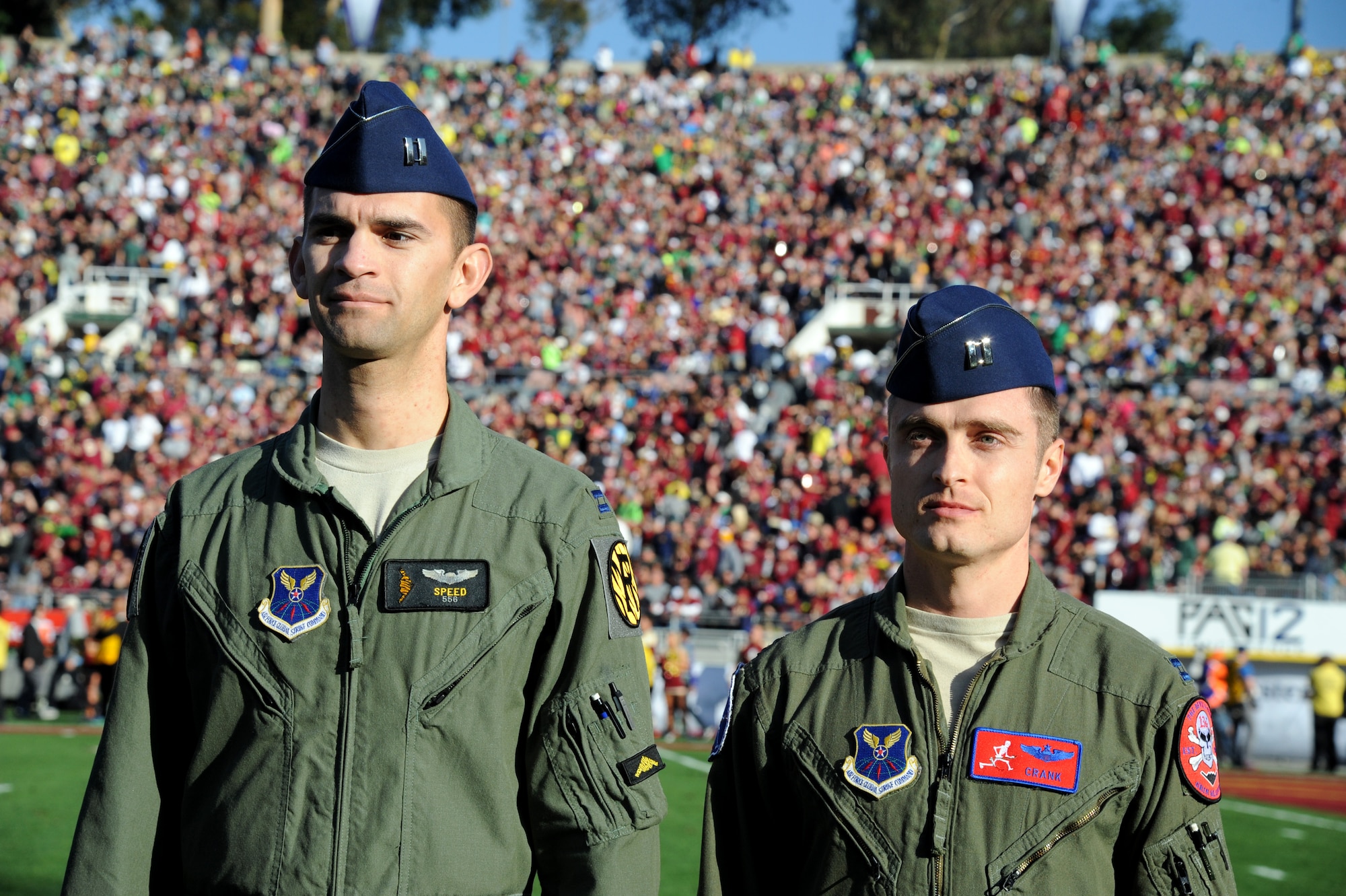 U.S. Air Force Capt. Christopher Conant, left, a B-2 Spirit stealth bomber pilot with the 13th Bomb Squadron, and Capt. Matthew Zulauf, a B-2 pilot with the 393rd Bomb Squadron, represent Whiteman Air Force Base, Mo., during the 101st Rose Bowl Game Jan. 1, 2015, in Pasadena, Calif. The game was attended by more than 90,000 fans and viewed on television by more than 28 million viewers. (U.S. Air Force photo by Staff Sgt. Brigitte N. Brantley/Released)