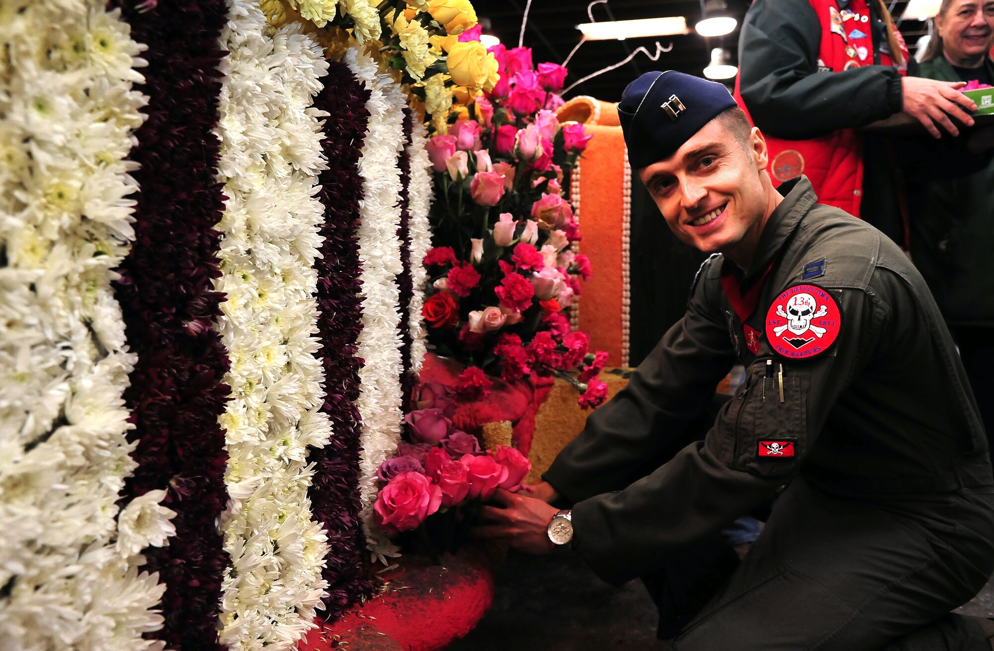 U.S. Air Force Capt. Christopher Conant, a 13th Bomb Squadron B-2 Spirit stealth bomber pilot from Whiteman Air Force Base, Mo., helps decorate a float Dec. 31, 2014, in Pasadena, Calif. The 126th annual Tournament of Roses Parade was attended by an estimated 750,000 people and viewed on television by 80 million viewers internationally. (U.S. Air Force photo by Staff Sgt. Brigitte N. Brantley/Released)