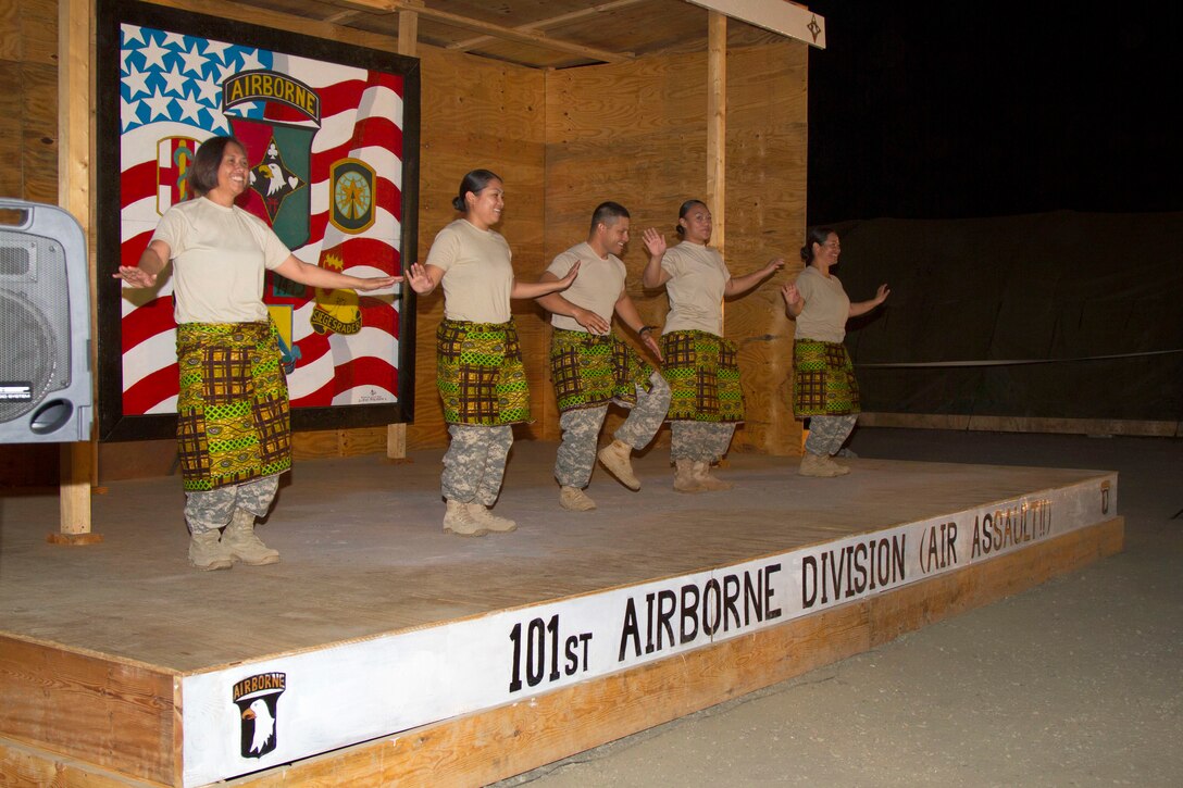 U.S. Army Sgt. 1st Class Christabel Jennings, from left, U.S. Army Warrant Officer Abigail Baker, U.S. Army Pfc. Timothy Cruz, U.S. Army Spc. Sally Rodriguez and U.S. Army Maj. Jessica Higa dance the Pate Pate dance for a talent show during a New Year celebration on Camp Buchanan in Buchanan, Liberia, Dec. 31, 2014. The soldiers are assigned to the 101st Airborne Division's 583rd Medical Logistics Company, along with members of the 101st Sustainment Brigade.