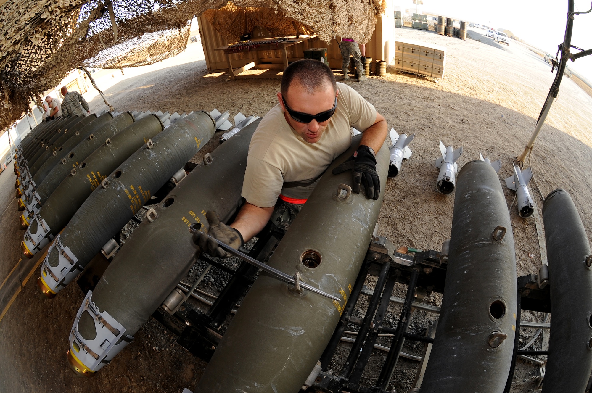 Master Sgt. Adam, NCO-in-charge of conventional maintenance, lines up bomb lugs on MK-82 munitions Dec. 21, 2014, in Southwest Asia, to ensure they are prepared to sync up with aircraft racks during installation.  Adam, deployed from Seymour Johnson Air Force Base, N.C., has been an Ammo troop for 14 years.  (U.S. Air Force photo/Senior Master Sgt. Carrie Hinson)