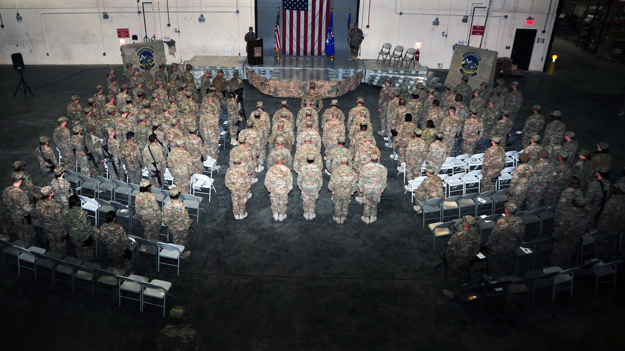 U.S. Air Force Airmen stand at attention to commemorate the formal inactivation of the 455th Expeditionary Aerial Port Squadron following a squadron inactivation ceremony Jan. 1 at Bagram Airfield, Afghanistan. The squadron, now belonging to the 455th Expeditionary Logistics Readiness Squadron, will henceforth be recognized as an aerial port flight. (U.S. Air Force photo by Staff Sgt. Whitney Amstutz/released)