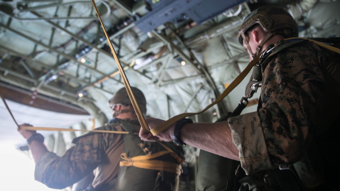 Marines prepare to jump from a KC-130J Super Hercules aircraft Nov. 20, 2014 over Ie Shima Training Facility, off the northwest coast of Okinawa, Japan. The low level static line jumps were performed at an altitude of 1,500 feet for the training. The Marines are with 3rd Reconnaissance Battalion, 3rd Marine Division, III Marine Expeditionary Force.