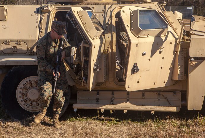 A Marine with Alpha Company, 2nd Transportation Support Battalion, 2nd Marine Logistics Group, conducts a dismount from an armored vehicle to conduct an improvised explosive device check during counter IED training aboard Camp Lejeune, N.C. Marines with 2nd TSB conducted the exercise to improve readiness, unit cohesion and maintain their skills for future deployments. (U.S. Marine Corps photo by Cpl. Joshua W. Brown/Released)