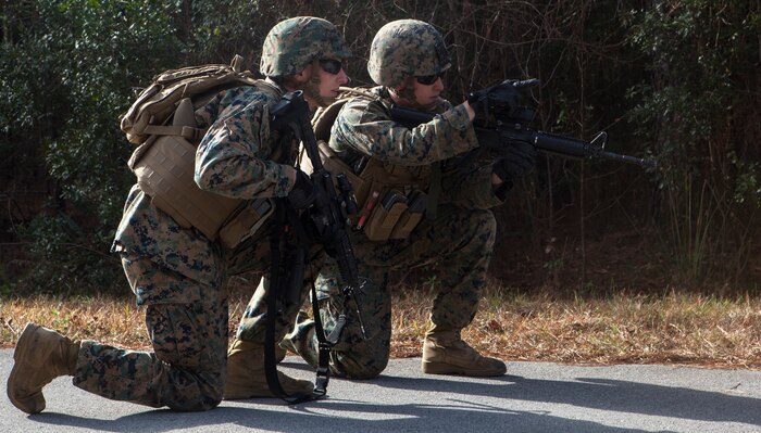 Two Marines with Alpha Company, 2nd Transportation Support Battalion, 2nd Marine Logistics Group, discuss how to move forward after spotting a possible simulated improvised explosive device during counter IED training aboard Camp Lejeune, N.C. Marines with 2nd TSB conducted the exercise to improve readiness, unit cohesion and maintain their skills for future deployments. (U.S. Marine Corps photo by Cpl. Joshua W. Brown/Released)