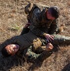 Two Marines with Alpha Company, 2nd Transportation Support Battalion, 2nd Marine Logistics Group practice tourniquet application during counter improvised explosive device training aboard Camp Lejeune, N.C. Marines with 2nd TSB conducted the exercise to improve readiness, unit cohesion and maintain their skills for future deployments. (U.S. Marine Corps photo by Cpl. Joshua W. Brown/Released)