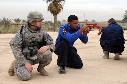 Sgt. Matthew Glassford, a Military Police officer assigned to the 217th Military Police Company from the Alabama National Guard, supervises an Iraqi highway patrol officer during a training scenario March 17 in Baghdad. The 217th has worked with the IHP for six months on basic police skills such as traffic stops, search warrants and ticket writing.