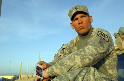 Spc. Joseph Carter holds a photo of his best friend, Anthony Owens, who was killed in combat action Feb. 1, 2006, south of Baghdad, Iraq. Carter is deployed with the 1/187 Field Artillery Battalion of the South Carolina National Guard as part of the Paktika Provincial Reconstruction Team. Carter enlisted in the U.S. Army to serve his country and honor the life of his friend, who died while serving his country in Iraq. Carter now carries a photo of his fallen friend in his wallet on every mission.