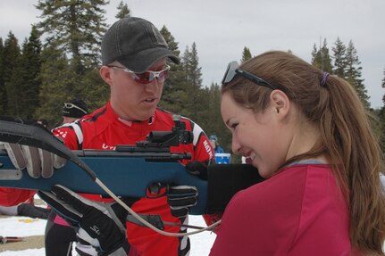 Sgt. Brandon Adams of the Utah National Guard assists Allie McDaniel, 15, at the Northstar-at-Tahoe biathlon range on in Truckee, Calif., March 20, 2010. Adams was one of six Guard biathletes who promoted biathlon at civilian events throughout California in March.