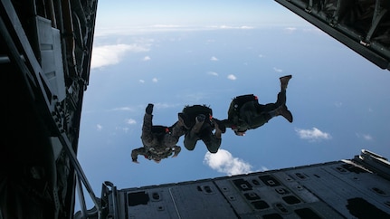 In this photo, Gunnery Sgt. Gabriel Machado, left, Master Sgt. Raul Argumedo, center, and Gunnery Sgt. Matthew Bateman jump in tandem from a KC-130J Super Hercules aircraft The Marines jumped from an altitude of 10,000 feet during the high speed training. Machado, from New York, New York, is an air delivery specialist with 3rd Reconnaissance Battalion, 3rd Marine Division, III Marine Expeditionary Force. Argumedo, from Los Angeles, California, is an air delivery specialist with the battalion. Bateman, from Gaithersburg, Maryland, is a reconnaissance man with the battalion. 