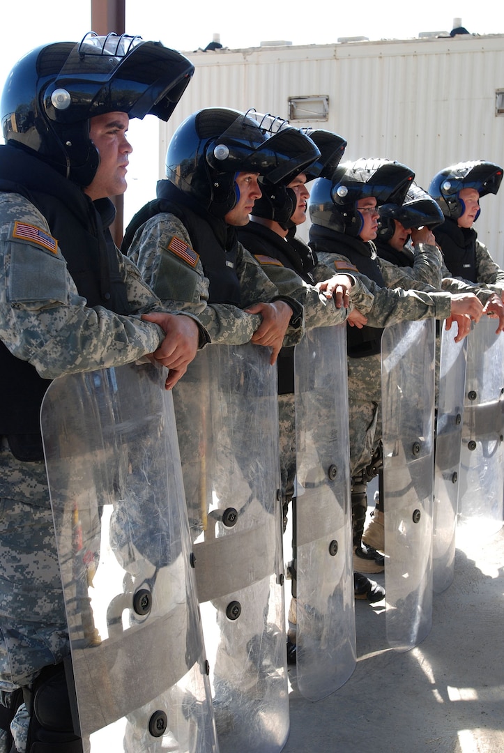 Members of the Rhode Island Army National Guard’s 115th Military Police Company Quick Reaction Force at Joint Task Force (JTF) Guantanamo take a break during training. QRF service members constantly train for a variety of situations ranging from camp riots to setting up roadblocks and checkpoints.