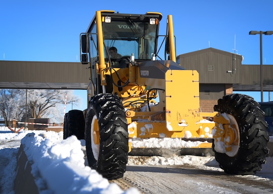 U.S. Air Force Senior Airman Corey Masquef, 27th Special Operations Civil Engineer Squadron pavement and construction equipment apprentice, utilizes a motor grader to clear areas of the main gate Jan. 5, 2015 at Cannon Air Force Base, N.M. Pavement and construction equipment Air Commandos have the critical task of constructing and maintaining concrete and asphalt runways, roads, operating and maintaining heavy construction equipment such as, loaders, graders, dozers, dump trucks, transporting construction equipment and materials, and ensuring compliance with all safety and environmental regulations. (U.S. Air Force photo/Staff Sgt. Alexxis Mercer) 