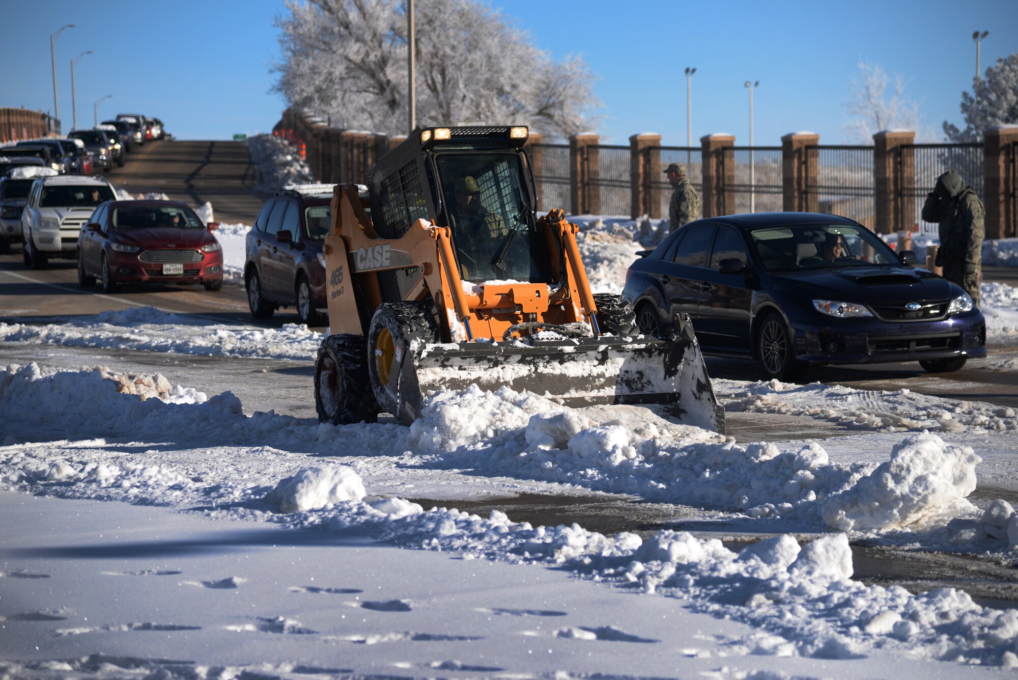 Jose Arguello, 27th Special Operations Civil Engineer Squadron heavy equipment operator, makes use of a skid steer to plow snow in front of the main gate Jan. 5, 2015 at Cannon Air Force Base, N.M. Cannon’s pavement and construction team has been working diligently to clear roadways and critical facilities to keep mission requirements going. (U.S. Air Force photo/Staff Sgt. Alexxis Mercer) 