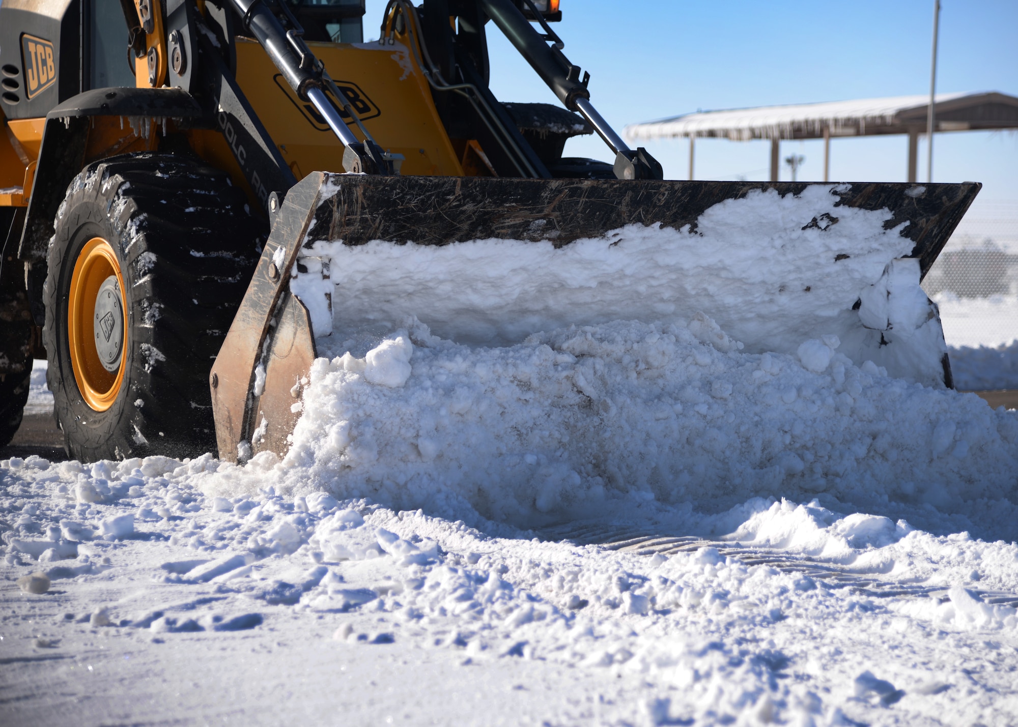A member of the 27th Special Operations Civil Engineer Squadron pavement and construction equipment team clears an icy and snow-covered road Jan. 5, 2015 at Cannon Air Force Base, N.M. The 27 SOCES gears efforts toward maintaining and protecting infrastructure such as roadways, airfield pavements and the surrounding base environment. (U.S. Air Force photo/Staff Sgt. Alexxis Mercer)