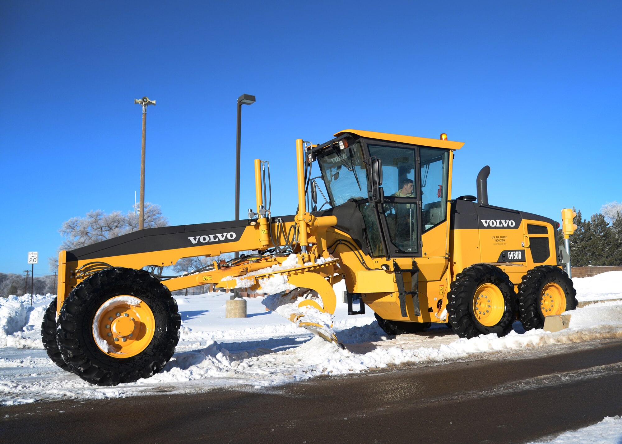 U.S. Air Force Senior Airman Corey Masquef, 27th Special Operations Civil Engineer Squadron pavement and construction equipment apprentice, operates a motor grader to clear snow near the main gate Jan. 5, 2015 at Cannon Air Force Base, N.M. Members of the 27th Special Operations Wing should remain patient while this on-going effort continues by the 27 SOCES team, and maintain vigilance while exercising caution during commutes. (U.S. Air Force photo/Staff Sgt. Alexxis Mercer) 