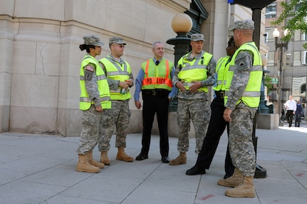 Members of the District of Columbia National Guard talk with officers from the Metropolitan Police Department's homicide branch while on duty at the nuclear summit in Washington, D.C., on April 12, 2010. The National Guard is supporting civilian authorities protecting 46 world leaders attending the summit.