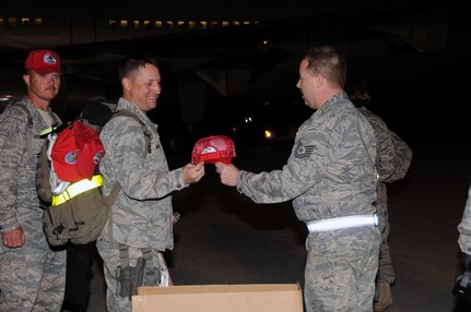 From left, Capt. Mark Burmbach and Maj. Eric Mannion received a fresh new
red hat from Tech. Sgt. Kevin Rakus when they returned to Fort Indiantown
Gap, Pa., after a six-month deployment to locations throughout Iraq and
Afghanistan. They were among the more than 100 returning Airmen of the 193rd
Special Operations Wing's 201st Rapid Engineer Deployable Heavy Operational
Repair Squadron Engineers. Their mission was to build and repair military
infrastructures that support missions theater wide.