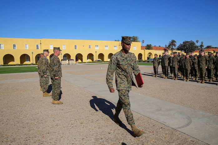 Cpl. Jason Martin, military police officer, Headquarters and Service Battalion, marches off after being awarded the Navy and Marine Corps Commendation Medal at Marine Corps Recruit Depot San Diego, Jan. 5.  Martin received the award for his heroic actions in saving the life of a woman caught in quickly rising flood waters.