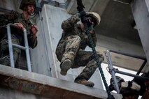 Marines hone their fast-roping skills Dec. 3 at the Camp Hansen rappel tower. The Marines gradually increased the difficulty, first rappelling without gear, then with their flak vests, and finally with their weapons. The Marines are with Company F, Battalion Landing Team 2nd Battalion, 4th Marines, 31st Marine Expeditionary Unit. (U.S. Marine Corps photo by Lance Cpl. Ryan C. Mains/Released)