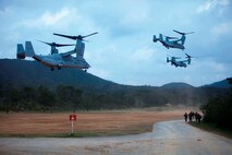 Three U.S. Marine MV-22 Ospreys with Marine Medium Tiltrotor Squadron 262 take off from a landing zone after dropping off Marines with Company E, Battalion Landing Team, 2nd Battalion 4th Marines, 31st Marine Expeditionary Unit (MEU), during a vertical assault while conducting the MEU Exercise (MEUEX), in Combat Town, Okinawa, Japan, Dec 10, 2014. BLT 2/4 is conducting training in preparation of their upcoming spring patrol. (U.S. Marine Corps photo by GySgt Ismael Pena/Released)