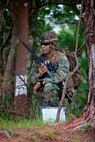 U.S. Marine with Company E, Battalion Landing Team, 2nd Battalion 4th Marines, 31st Marine Expeditionary Unit (MEU), listens to radio transmitions during a vertical assault as part of  the MEU Exercise (MEUEX), in Combat Town, Okinawa, Japan, Dec 10, 2014. BLT 2/4 is conducting training in preparation of their upcoming spring patrol. (U.S. Marine Corps photo by GySgt Ismael Pena/Released)