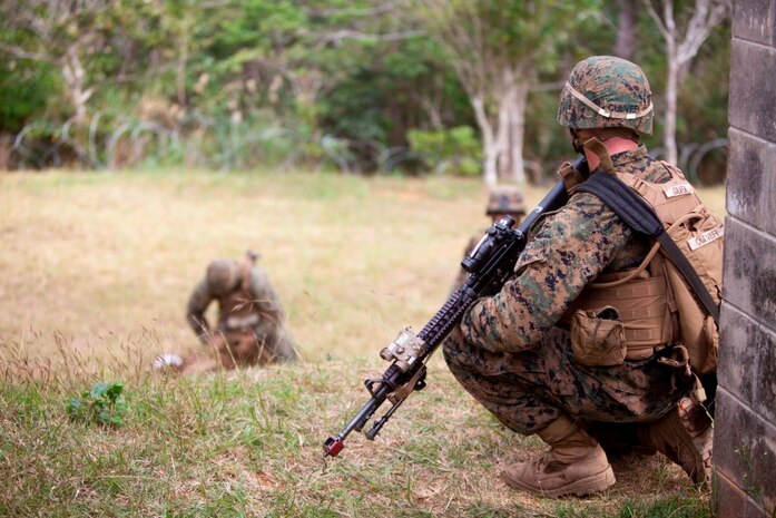 U.S. Marine with Company E, Battalion Landing Team, 2nd Battalion 4th Marines, 31st Marine Expeditionary Unit (MEU), provides security during a vertical assault as part of  the MEU Exercise (MEUEX), in Combat Town, Okinawa, Japan, Dec 10, 2014. BLT 2/4 is conducting training in preparation of their upcoming spring patrol. (U.S. Marine Corps photo by GySgt Ismael Pena/Released)