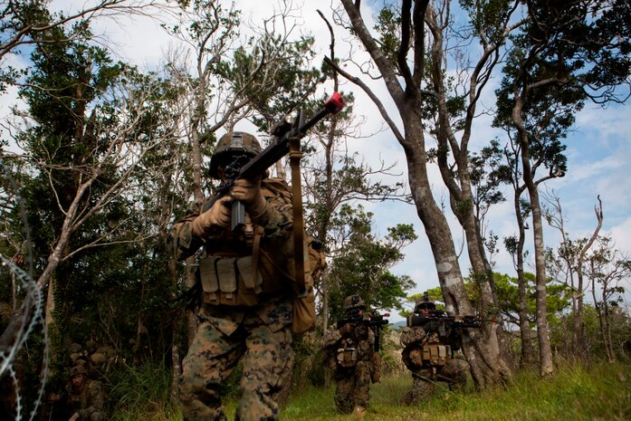 U.S Marines with Company E, Battalion Landing Team 2nd Battalion, 4th Marines, (BLT) 31st Marine Expeditionary Unit, provides security while conducting a vertical assault at Combat Town, Okinawa, Japan, Dec 8, 2014. Company E. is conducting training as part of the MEU Exercise and pre-deployment training. (U.S. Marine Corps Photo by Lance Cpl. Richard Currier/ Released)