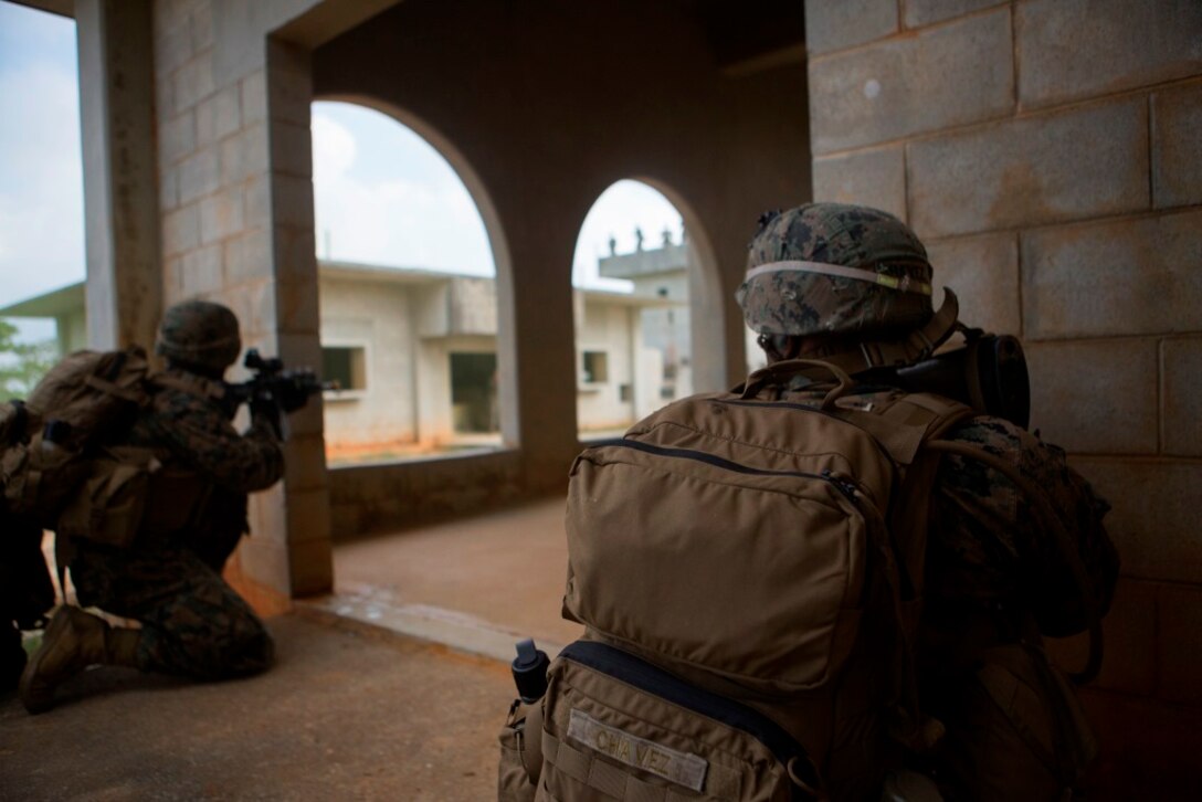 U.S. Marines with Company E, Battalion Landing Team 2nd Battalion, 4th Marines, (BLT) 31st Marine Expeditionary Unit, engage targets while conducting a vertical assault at Combat Town, Okinawa, Japan, Dec. 8, 2014. Company E is conducting training as part of the MEU Exercise and pre-deployment training. (U.S. Marine Corps Photo by Lance Cpl. Richard Currier/ Released)