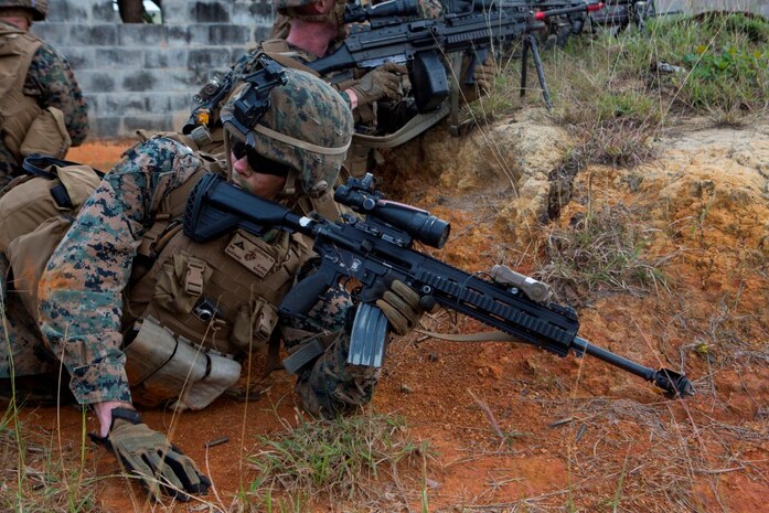 U.S. Marine Corps Lance Cpl. Thomas Hardy, rifleman, Company E, Battalion Landing Team 2nd Battalion, 4th Marines, (BLT) 31st Marine Expeditionary Unit, yells orders to other Marines while conducting a vertical assault at Combat Town, Okinawa, Japan, Dec. 8, 2014. Company E is conducting training as part of the MEU Exercise and pre-deployment training. (U.S. Marine Corps Photo by Lance Cpl. Richard Currier/ Released)