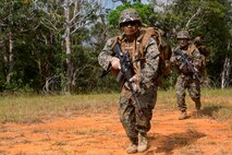 U.S. Marine Corps Lance Cpl. Renea Rivas (front), rifleman, Company E, Battalion Landing Team 2nd Battalion, 4th Marines, (BLT) 31st Marine Expeditionary Unit, moves towards targets while conducting a Helo Raid at Combat Town, Okinawa, Japan, Dec. 8, 2014. Company E is conducting training as part of the MEU Exercise and pre-deployment training. (U.S. Marine Corps Photo by Lance Cpl. Richard Currier/ Released)