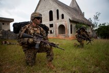 U.S. Marine Corps Lance Cpl. Jonathan Baird (left), rifleman, Company E, Battalion Landing Team 2nd Battalion, 4th Marines, (BLT) 31st Marine Expeditionary Unit, provides security while conducting a Helo Raid at Combat Town, Okinawa, Japan, Dec. 8, 2014. Company E is conducting training as part of the MEU Exercise and pre-deployment training. (U.S. Marine Corps Photo by Lance Cpl. Richard Currier/ Released)