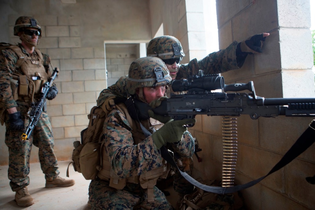 U.S. Marine Corps Lance Cpl. Mathew Locket (back) directs field of fire for Lance Cpl. Taylor Abott (front), rifleman, Company E, Battalion Landing Team 2nd Battalion, 4th Marines, (BLT) 31st Marine Expeditionary Unit, while conducting a Helo Raid at Combat Town, Okinawa, Japan, Dec. 8, 2014. Company E is conducting training as part of the MEU Exercise and pre-deployment training. (U.S. Marine Corps Photo by Lance Cpl. Richard Currier/ Released)