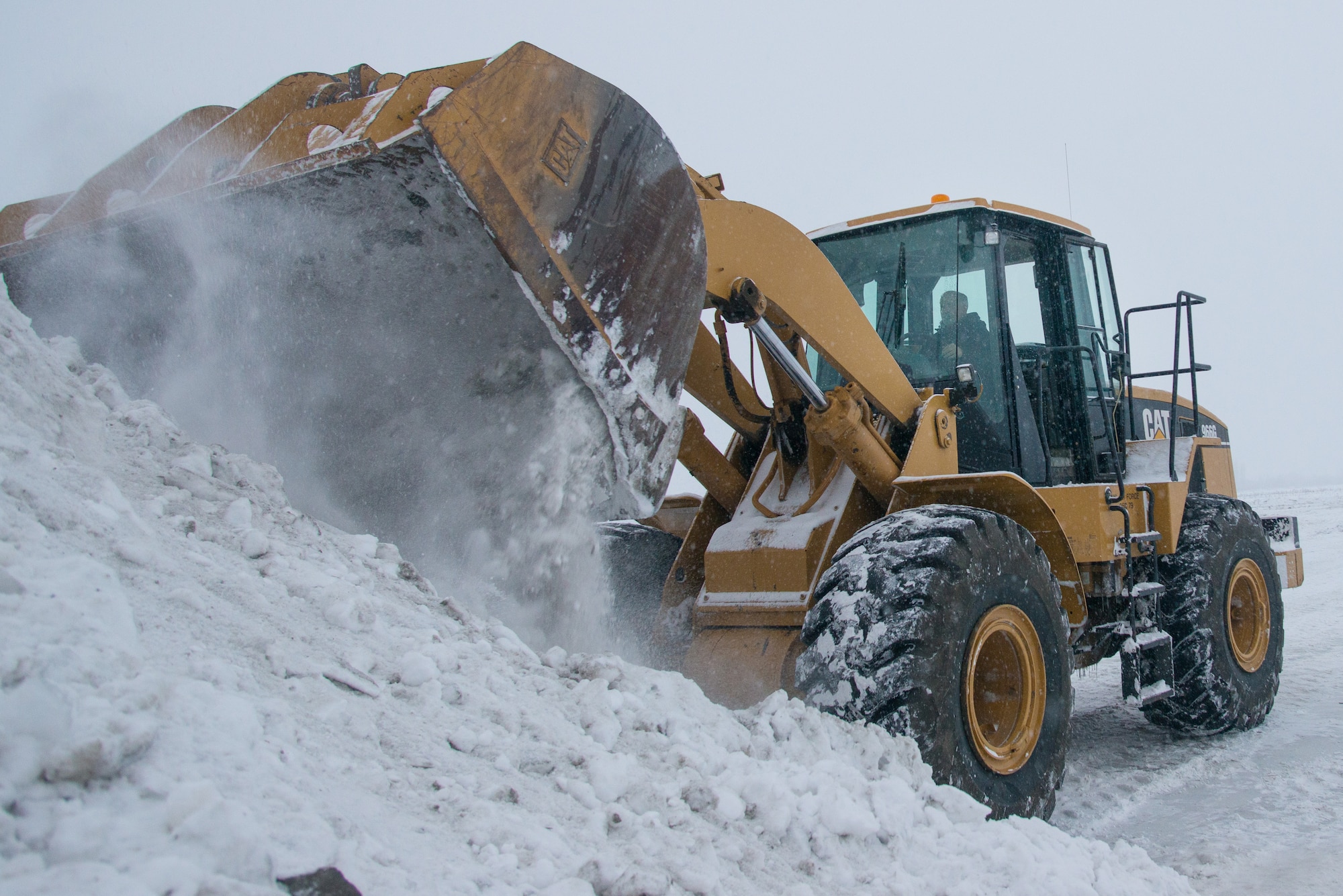 Perry Skow, the horizontal and range maintenance superintendent assigned to the 354th Civil Engineer Squadron, uses a tractor to build an ice bridge in Fairbanks, Alaska, Dec. 2, 2014. The bridge must be constructed every other year to provide access to the $20 million range complex used to train pilots from around the world during RED FLAG-Alaska exercises.  (U.S. Air Force photo by Tech. Sgt. Joseph Swafford/Released)
