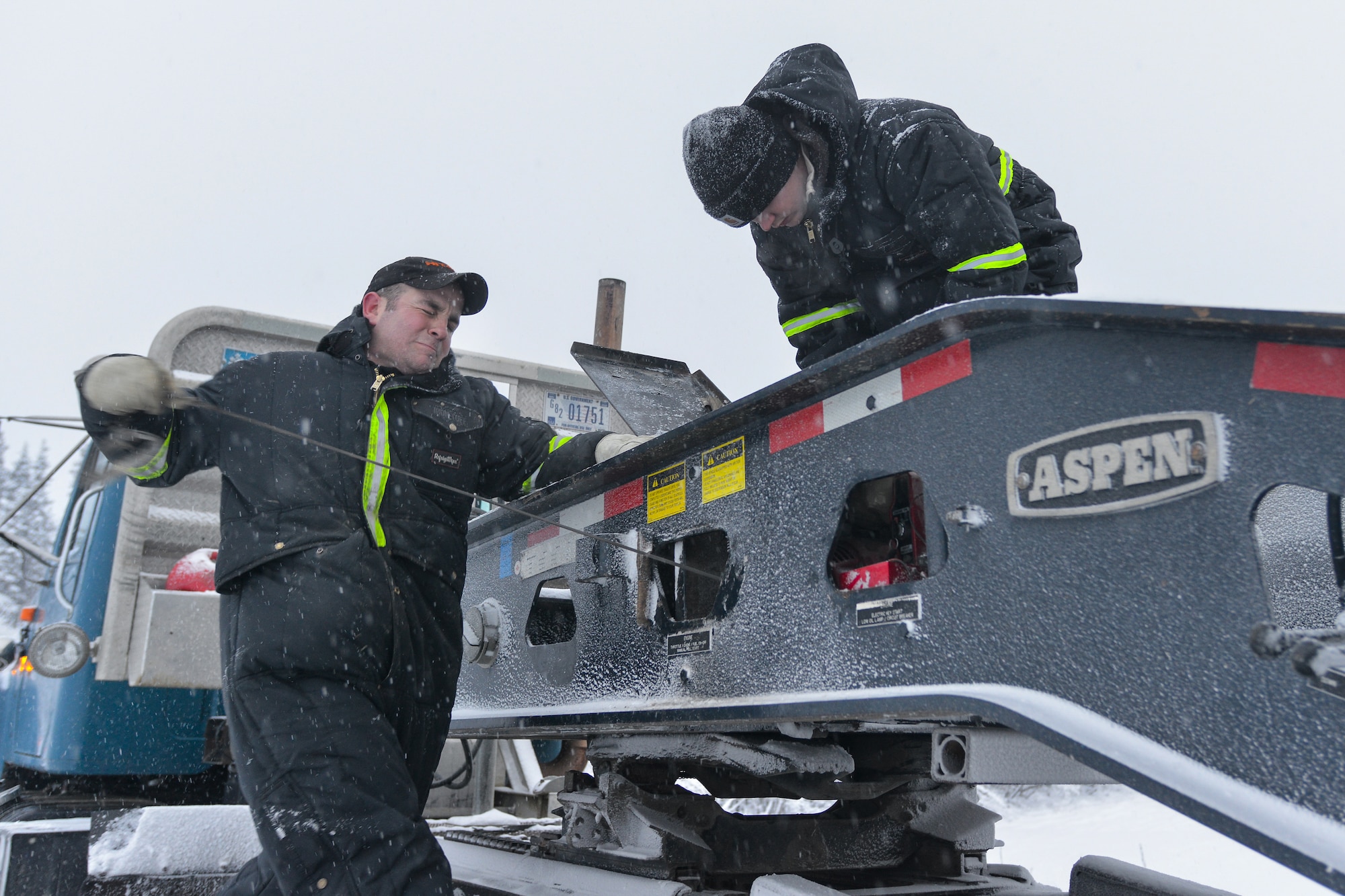 U.S. Air Force Senior Airman Tyler Dray, a range maintenance structures journeyman assigned to the 354th Civil Engineer Squadron, attempts to start a motor for a flat bed trailer used in building an ice bridge in Fairbanks, Alaska, Dec. 2, 2014. The bridge must be constructed every other year to provide access to the $20 million range complex used to train pilots from around the world during RED FLAG-Alaska exercises.  (U.S. Air Force photo by Tech. Sgt. Joseph Swafford/Released)
