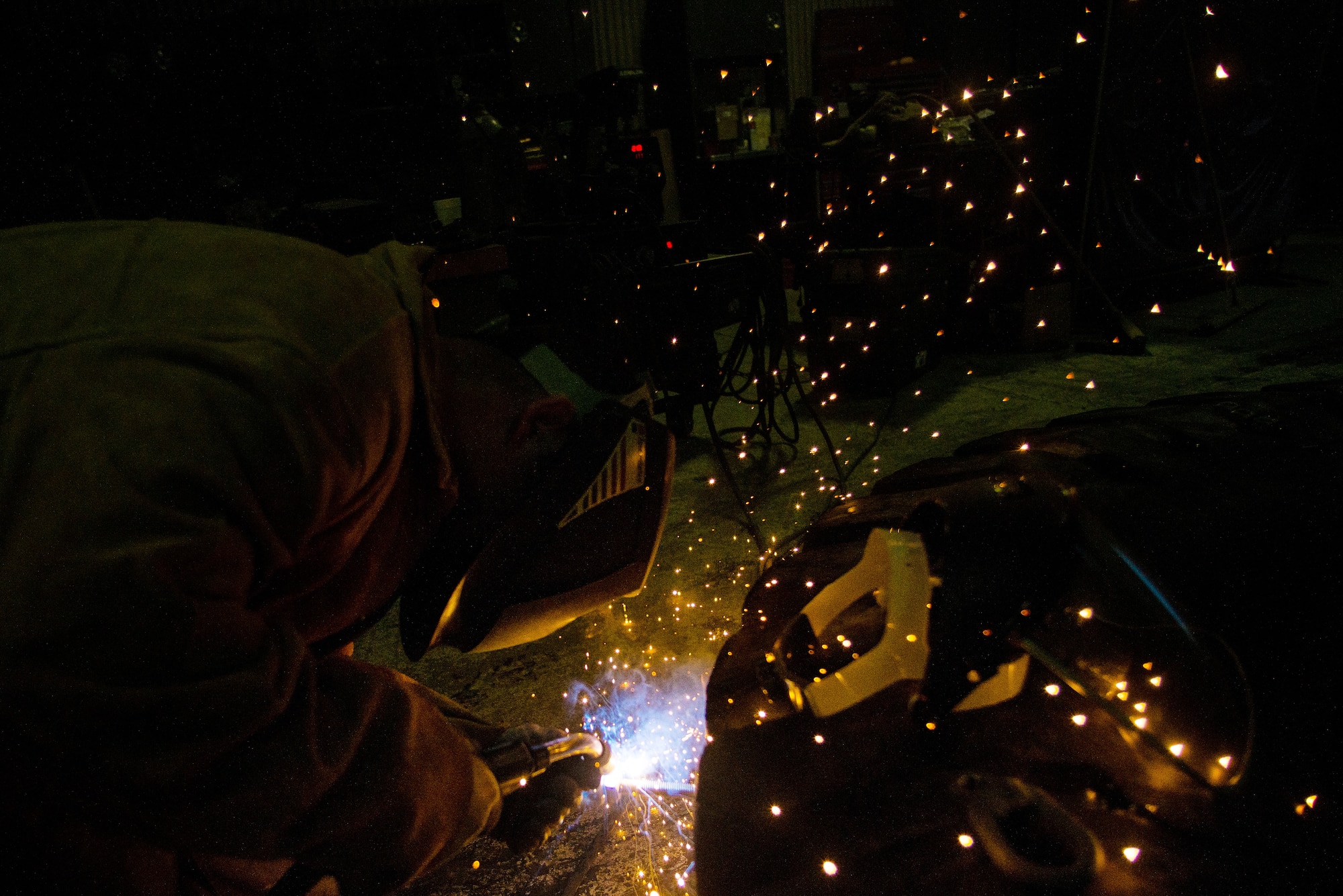 U.S. Air Force Senior Airman John Lee, a range maintenance structures journeyman assigned to the 354th Civil Engineer Squadron, welds material for use in constructing an ice bridge Dec. 2, 2014, at Eielson Air Force Base, Alaska. The bridge must be constructed every other year to provide access to the $20 million range complex used to train pilots from around the world during RED FLAG-Alaska exercises.  (U.S. Air Force photo by Tech. Sgt. Joseph Swafford/Released)
