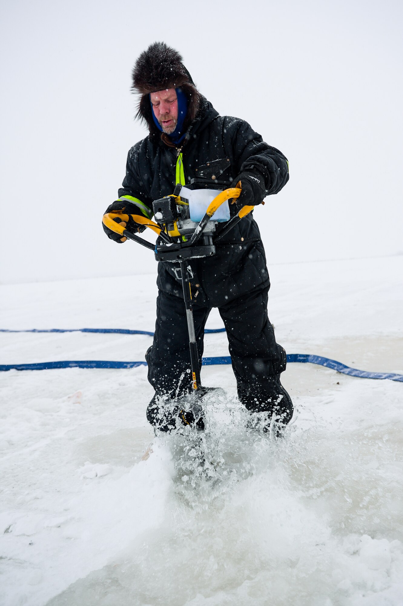 Shawn Kelly, the range maintenance foreman with the 354th Civil Engineer Squadron, uses an ice auger while constructing a ice bridge in Fairbanks, Alaska, Dec. 4, 2014. The bridge must be constructed every other year to provide access to the $20 million range complex used to train pilots from around the world during RED FLAG-Alaska exercises.  (U.S. Air Force photo by Staff Sgt. Shawn Nickel/Released)
