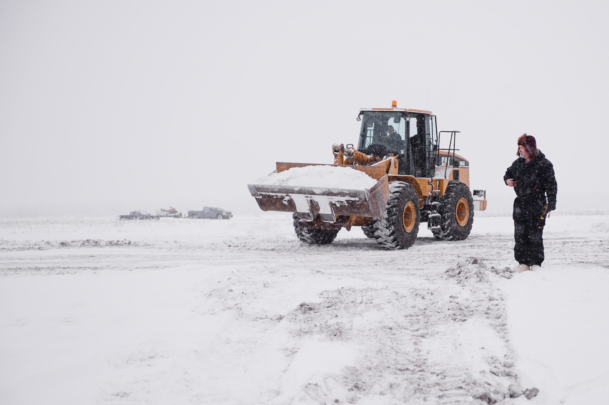 Shawn Kelly, the range maintenance foreman with the 354th Civil Engineer Squadron, looks on while his team members build an ice bridge in Fairbanks, Alaska, Dec. 4, 2014. The bridge must be constructed every other year to provide access to the $20 million range complex used to train pilots from around the world during RED FLAG-Alaska exercises.  (U.S. Air Force photo by Staff Sgt. Shawn Nickel/Released)
