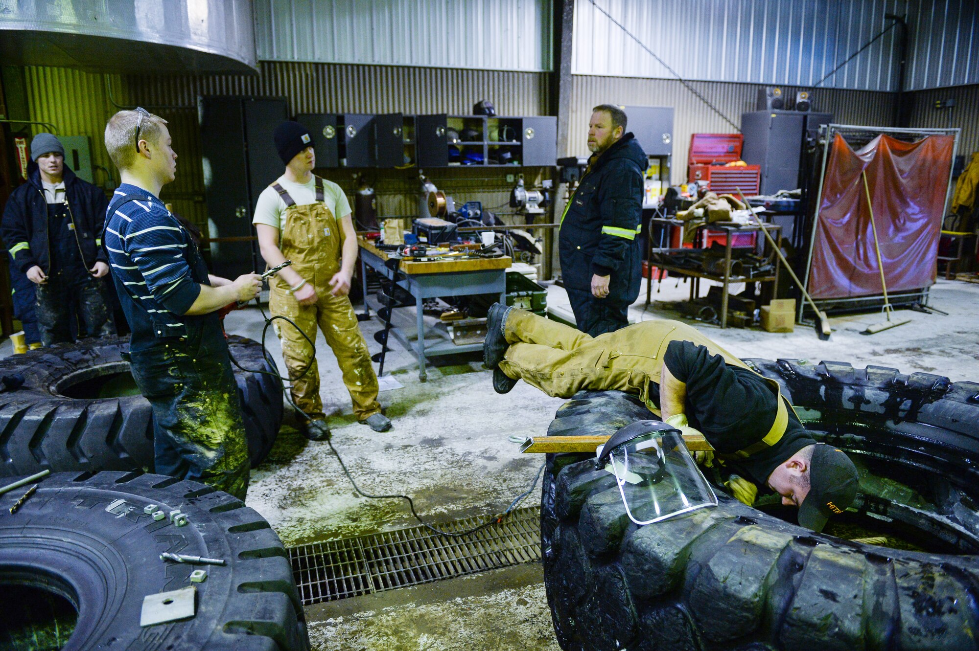 Members of the 354th Civil Engineer Squadron prepare equipment to be used to construct an ice bridge Dec. 2, 2014, at Eielson Air Force Base, Alaska. The bridge must be constructed every other year to provide access to the $20 million range complex used to train pilots from around the world during RED FLAG-Alaska exercises.  (U.S. Air Force photo by Staff Sgt. Shawn Nickel/Released)
