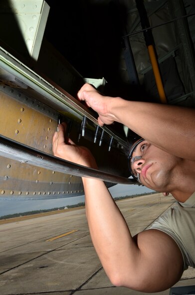 Tech. Sgt. Michael Rutherford, a maintenance crew member with the 403rd Fabrication Flight, works to patch a puncture in the sheet metal on the ramp of an 815th Airlift Squadron C-130J. (U.S. photo/Master Sgt. Brian Lamar)
