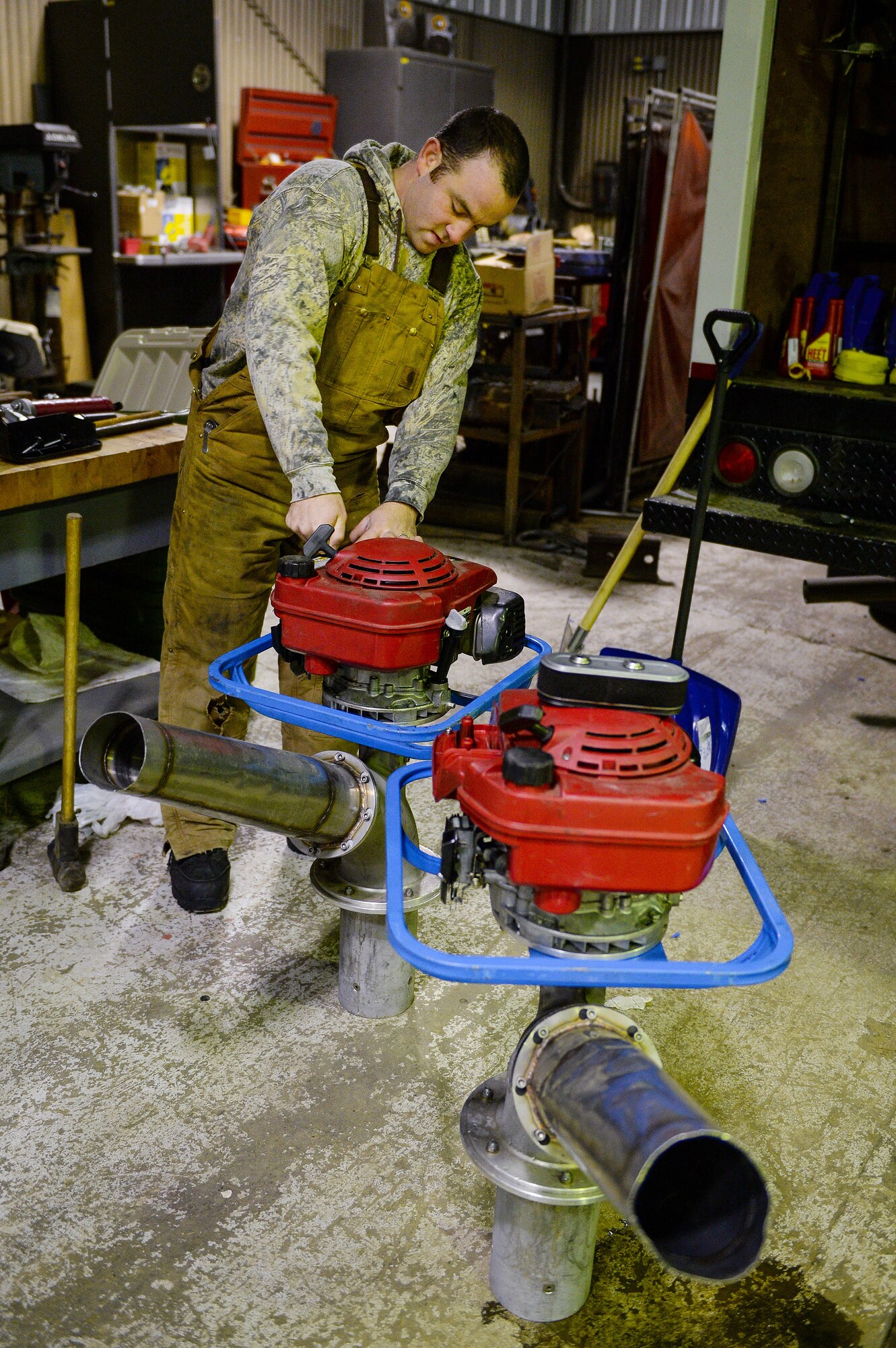 U.S. Air Force Senior Airman Tyler Dray, a range maintenance structures journeyman assigned to the 354th Civil Engineer Squadron, prepares equipment to be used to construct an ice bridge Dec. 2, 2014, at Eielson Air Force Base, Alaska. The bridge must be constructed every other year to provide access to the $20 million range complex used to train pilots from around the world during RED FLAG-Alaska exercises.  (U.S. Air Force photo by Staff Sgt. Shawn Nickel/Released)
