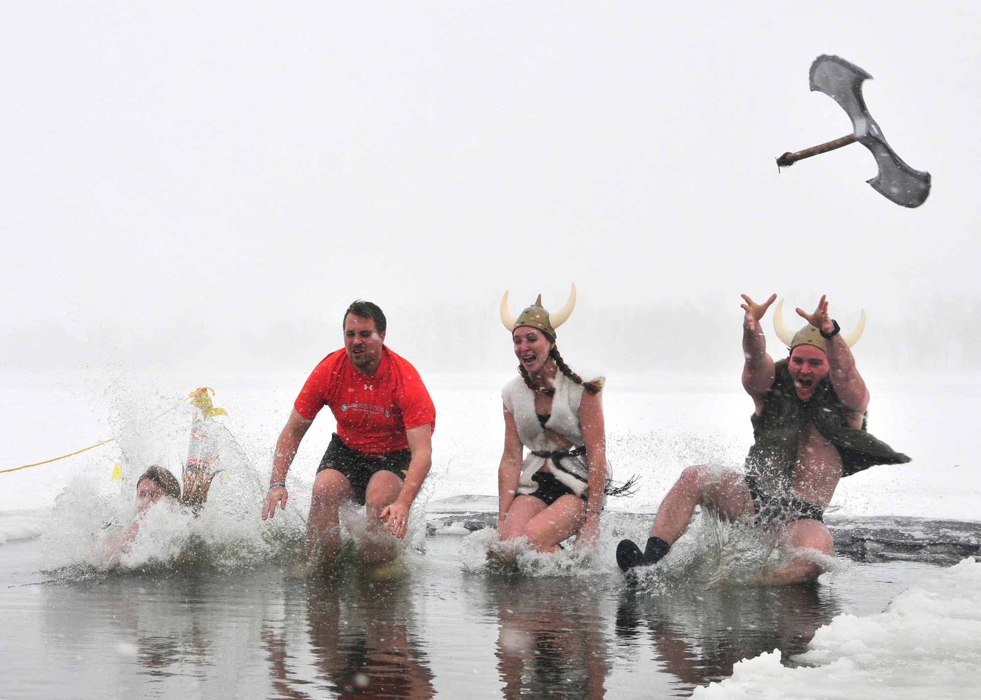 1st Lt. Justin Harrison (far right), 90th Civil Engineer Squadron explosive ordnance flight chief, and his team, jumps into the icy waters of Sloans Lake, Cheyenne, Wyo., Jan. 3, 2015. Harrison and his team participated in the third annual Schwartz Memorial Plunge in honor of Tech. Sgt. Matthew Schwartz, a 90th CES explosive ordnance technician who was killed in action while deployed to Afghanistan Jan. 5, 2012. The event raised funds for the EOD Warrior Foundation. (U.S. Air Force Photo/Lan Kim)
