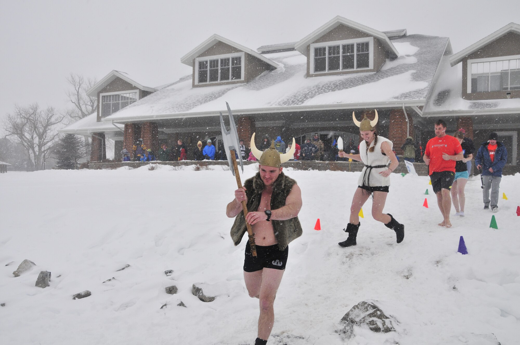 1st Lt. Justin Harrison, 90th Civil Engineer Squadron explosive ordnance flight chief, leads his team onto Sloans Lake, Cheyenne, Wyo., Jan. 3, 2015. Harrison and his team participated in the third annual Schwartz Memorial Plunge in honor of Tech. Sgt. Matthew Schwartz, a 90th CES explosive ordnance technician who was killed in action while deployed to Afghanistan Jan. 5, 2012. (U.S. Air Force Photo/Lan Kim)
