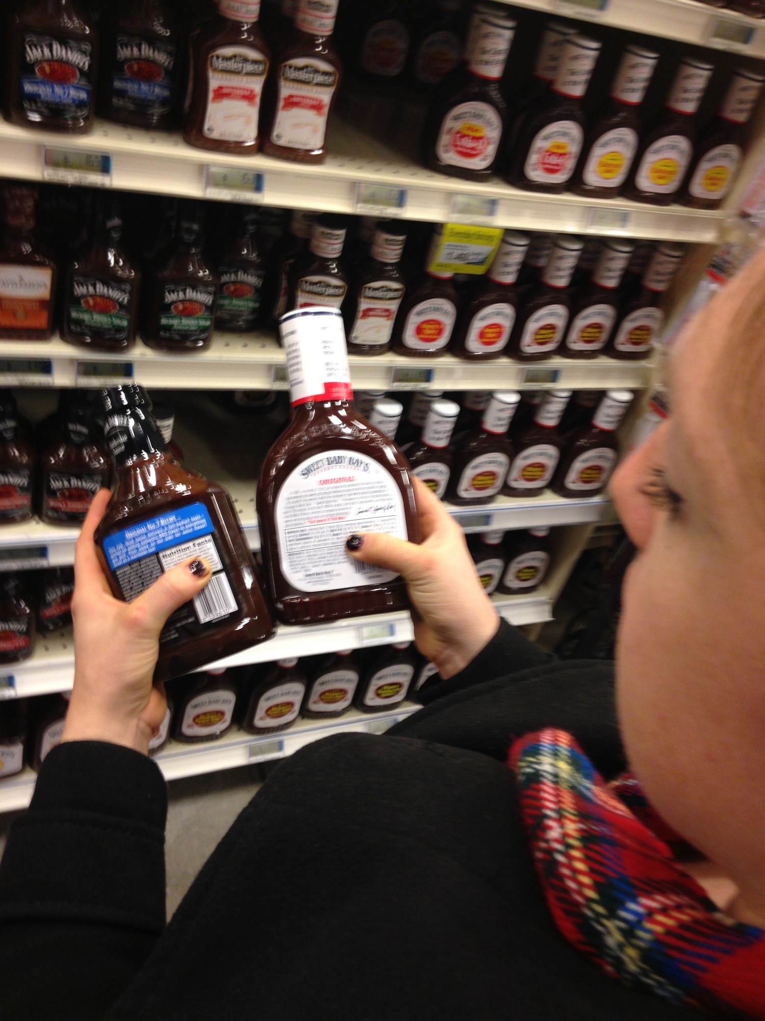 PETERSON AIR FORCE BASE, Colo. -- Tiffany Brunton, 21st Medical Group health promotion dietician, compares labels on two popular brands in the Peterson Air Force Base Commissary. Examining labels on condiments makes healthy selections throughout the store simple. (U.S. Air Force photo by Dave Smith)