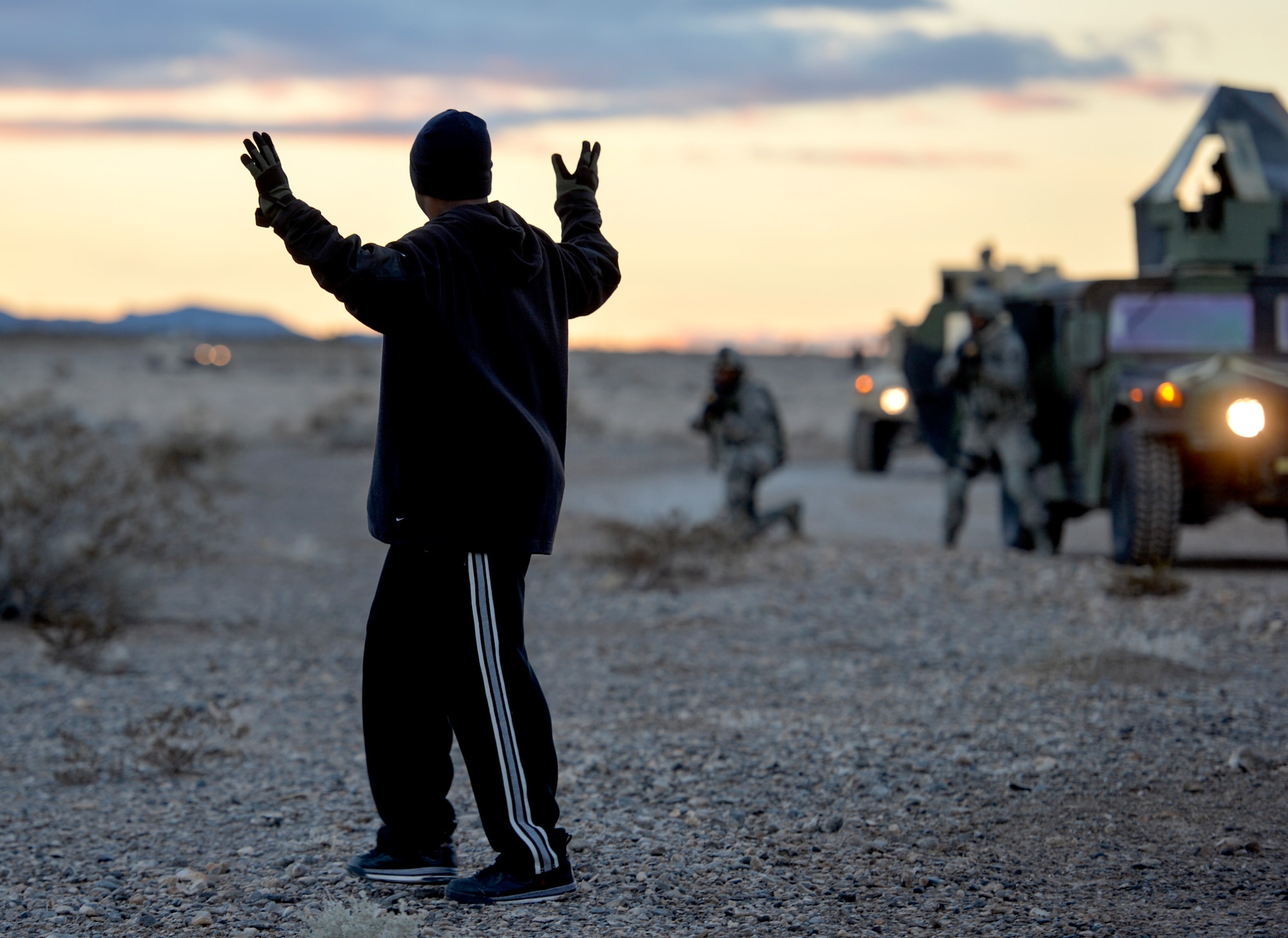 Security Forces Airmen attending the Base Security Operations course at the Silver Flag Alpha Range Complex north of Las Vegas drive HUMVEEs through desert terrain as they demonstrate skills to perform mounted and dismounted operations Dec. 18, 2014. This is the last BSO course that will take place at Silver Flag Alpha, as the 99th Ground Combat Training Squadron is projected to close in early 2015. All Air Force tactical security forces based training will be moved to the new Desert Defender Ground Combat Readiness Training Center at Fort Bliss, Texas. (U.S. Air Force photo by Tech. Sgt. Nadine Barclay/Released)