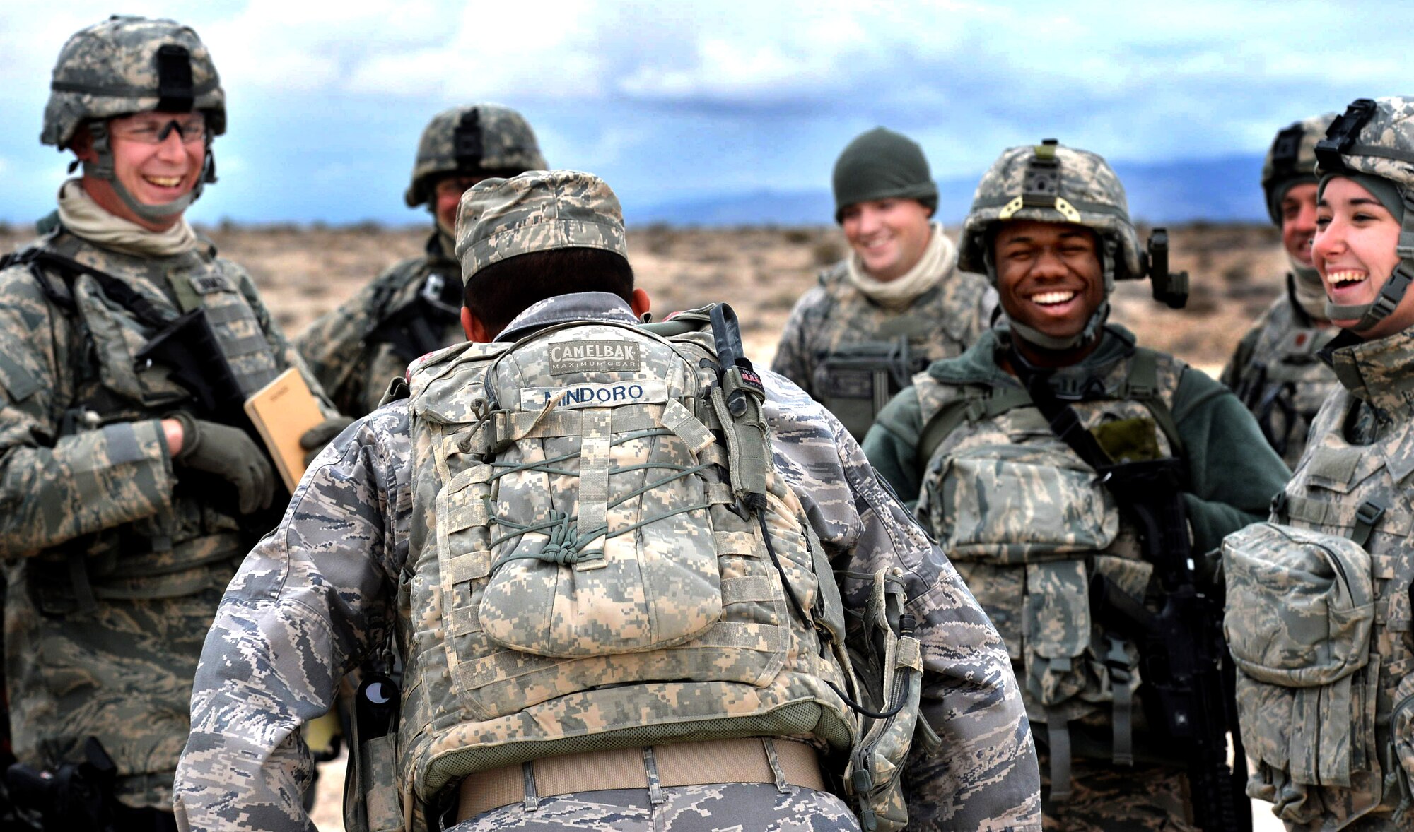 Tech. Sgt. Markus Mindoro, 99th Ground Combat Training Squadron integrated base defense course flight chief, jokes with students attending the last 99th GCTS Base Security Operations course at the Silver Flag Alpha Range Complex north of Las Vegas Dec. 17, 2014. The 99th GCTS is set to close in early 2015, and all Air Force tactical security forces-based training will be moved to the new Desert Defender Ground Combat Readiness Training Center at Fort Bliss, Texas. (U.S. Air Force photo by Tech. Sgt. Nadine Barclay/Released)