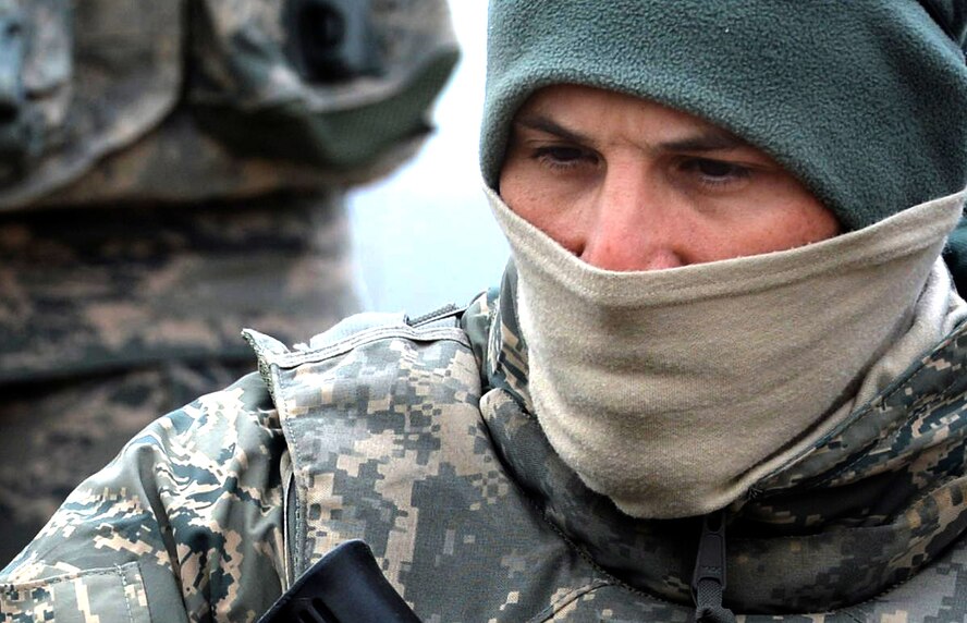 Senior Airmen Marcos Parisi, Base Security Operations course student, listens to instructions given by 99th Ground Combat Training Squadron cadre during the dismounted operations portion of the course at the Silver Flag Alpha Range Complex north of Las Vegas Dec. 17, 2014. Parisi is training for his first deployment and is currently assigned to the 512th Security Forces Squadron at Dover Air Force Base, Delaware.  This is the last BSO course that will take place at Silver Flag Alpha, as the training location is set to close in early 2015. (U.S. Air Force photo by Tech. Sgt. Nadine Barclay/Released)