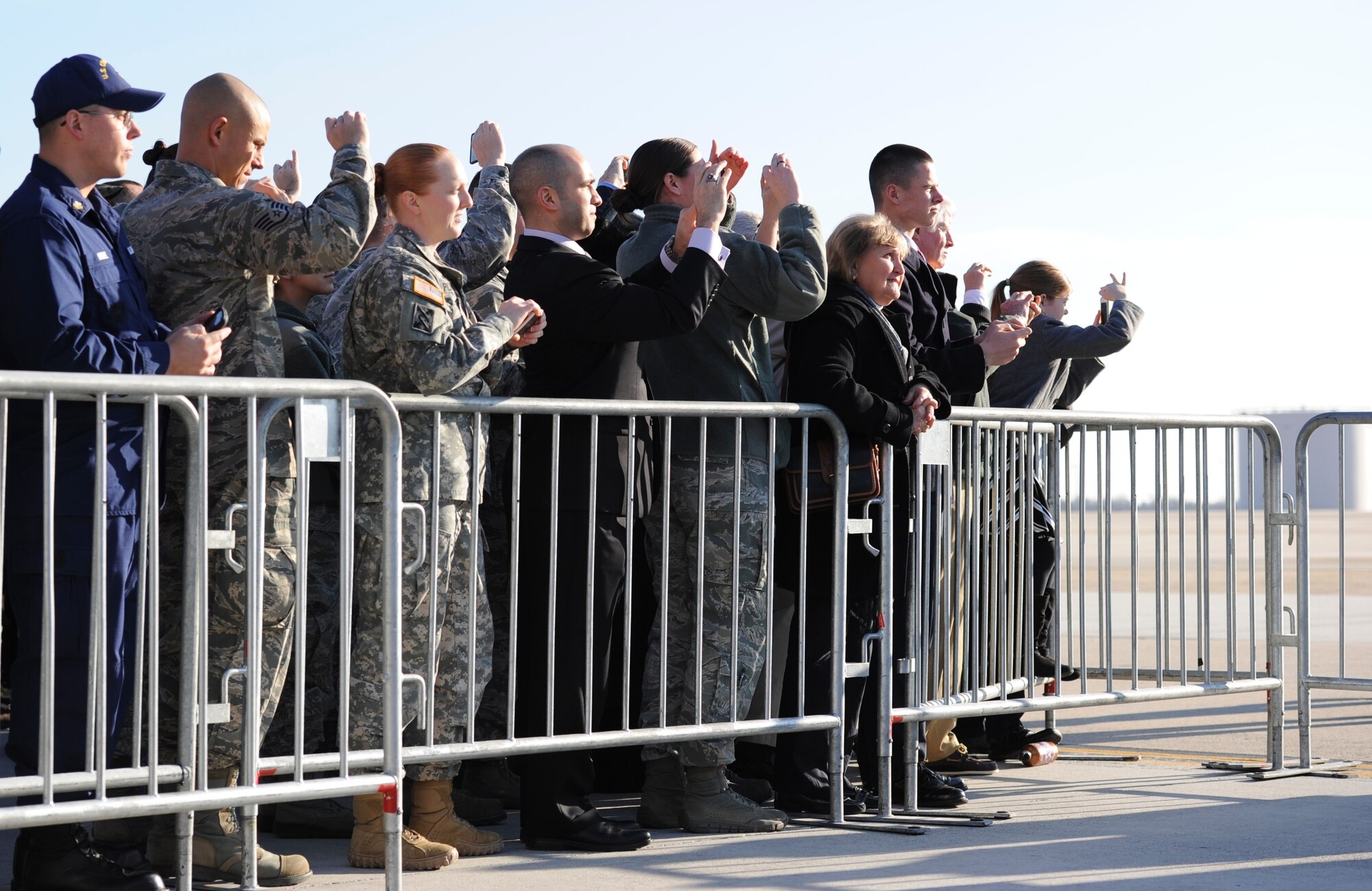 Anthony Quattrone, a security specialist for the Army Reserve's 99th Regional Support Command, center, readies his phone's camera just prior to meeting President Barack Obama Dec. 15 at Joint Base McGuire-Dix-Lakehurst, N.J. Quattrone was chosen to be part of a select group that would meet the president during his visit to the Garden State. (U.S. Air Force photo by Airman 1st Class Sean M. Crowe/Released)